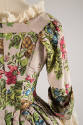 Detail back view of mauve floral brocade gown showing pink, green, brown, and blue brocade and …