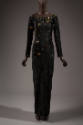 Black velvet long sleeve floor length dress with gold metal stars at neckline and scattered acr…