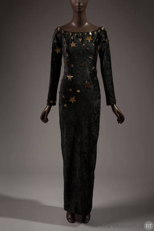 Black velvet long sleeve floor length dress with gold metal stars at neckline and scattered acr…