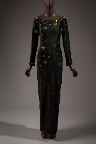 Black velvet long sleeve floor length dress with gold metal stars at neckline and scattered acr…
