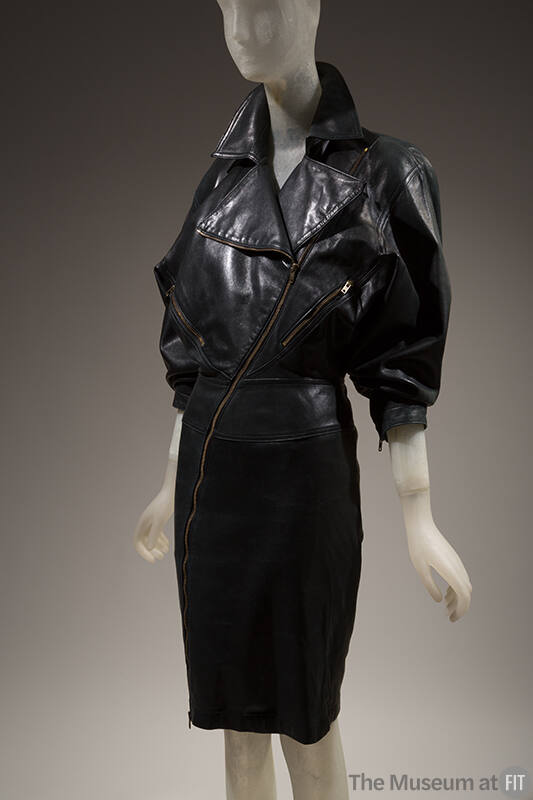Black motorcycle jacket dress: oversize bodice, fitted pencil skirt; wide lapels; asymmetrical …