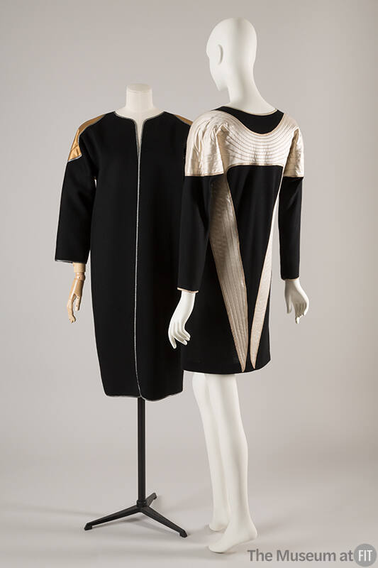 Black collarless coat with quilted gold wing motif at shoulders; coordinating long sleeve dress…
