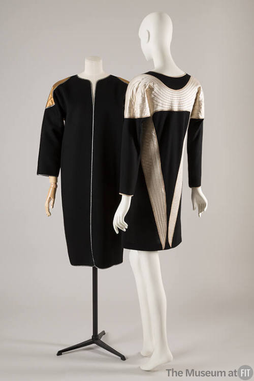 Black collarless coat with quilted gold wing motif at shoulders; coordinating long sleeve dress…