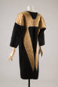 Black long sleeve dress with quilted gold wing motif at shoulders and back
