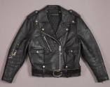 Black motorcyle jacket with silver zippers and snaps; coordinating black belt with large silver…