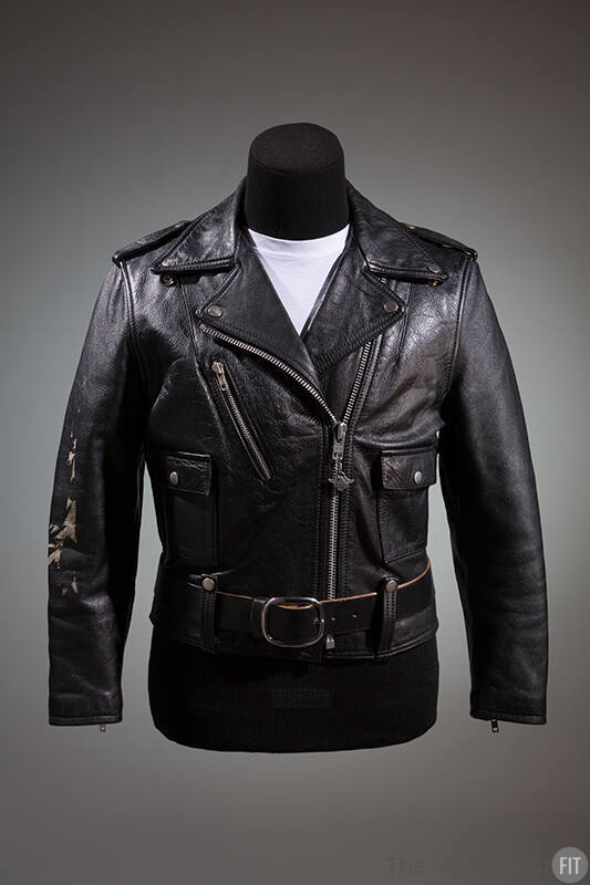 Black motorcyle jacket with silver zippers and snaps; coordinating black belt with large silver…