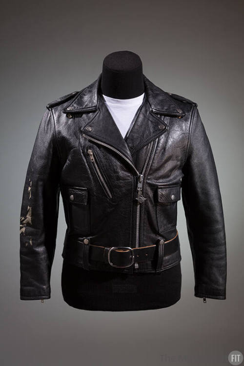 Black motorcyle jacket with silver zippers and snaps; coordinating black belt with large silver…