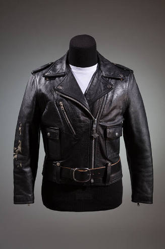 Black motorcyle jacket with silver zippers and snaps; coordinating black belt with large silver…