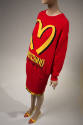 red sweater with yellow "Moschino Over 20 Billion Served" print and large yellow "M" and machin…