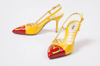 yellow pumps and a yellow "M" on red toebox