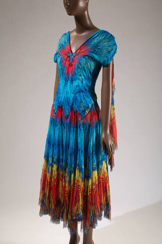 Blue, red, yellow and orange feather print evening dress with cap sleeves, scarf panel at back …
