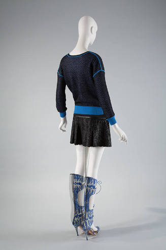 Back view of blue mesh sweatshirt with royal blue trim, black pleated mini skirt and blue and w…