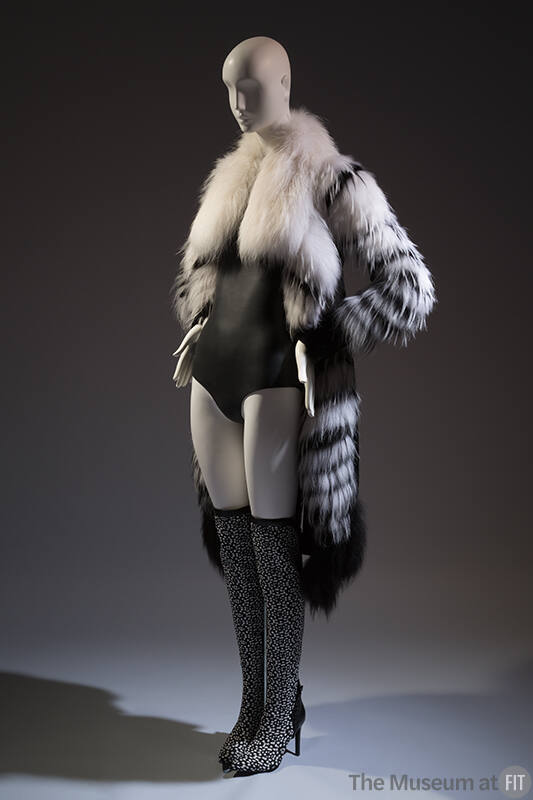 Open front black and white fur coat with oversize collar over black bodysuit and black and whit…