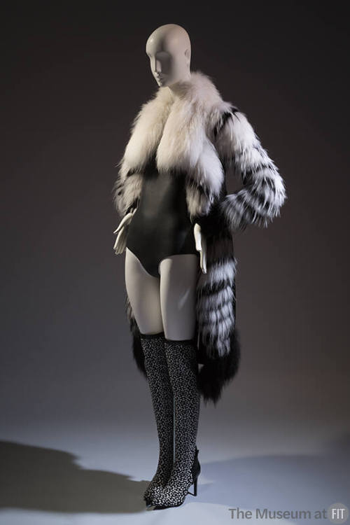 Open front black and white fur coat with oversize collar over black bodysuit and black and whit…