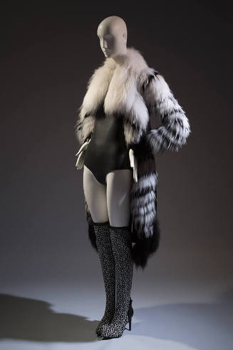 Open front black and white fur coat with oversize collar over black bodysuit and black and whit…