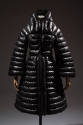 Black puffer coat with horizontal quilting, stand collar, bell sleeves, fitted waist and flared…