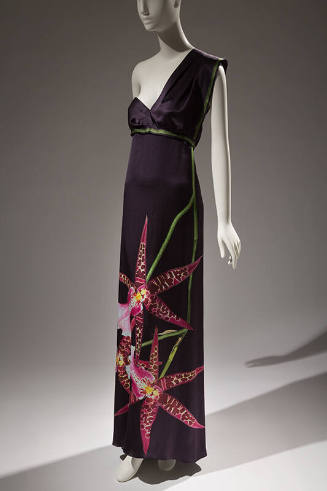 Dark grey one shoulder floor length dress with empire waist trimmed in green and oversize pink …