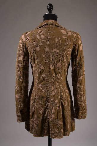 Back view of jacket in brown and beige floral pattern reverse applique and slightly flared from…