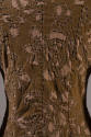 Detail view of brown and beige floral pattern jacket showing topstitching and raw edges around …