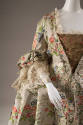 Detail view of ivory brocade robe a la francaise dress showing gold triangular bodice panel, la…