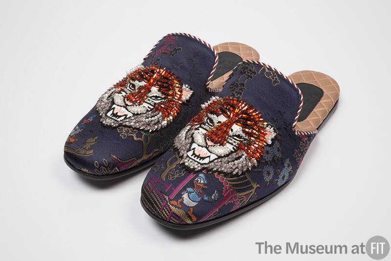 Pair of blue silk brocade evening slippers of Asian motifs and Donald Duck with orange, white a…