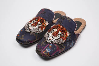 Pair of blue silk brocade evening slippers of Asian motifs and Donald Duck with orange, white a…