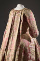 Back view of pink robe a la francaise gown showing large pleat at center back neck extending do…