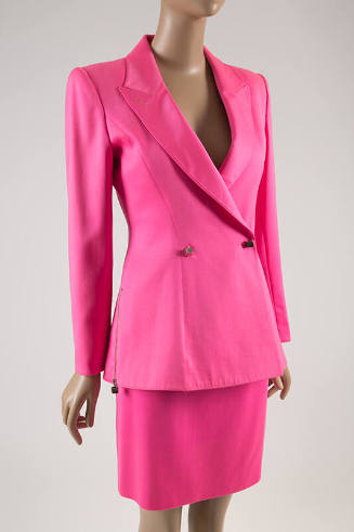 Bright pink suit of peak lapel jacket with side zipper and two button closure in the shape of s…