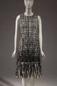 Black and white tweed sleeveless dress with extended hem fringe of feathers 