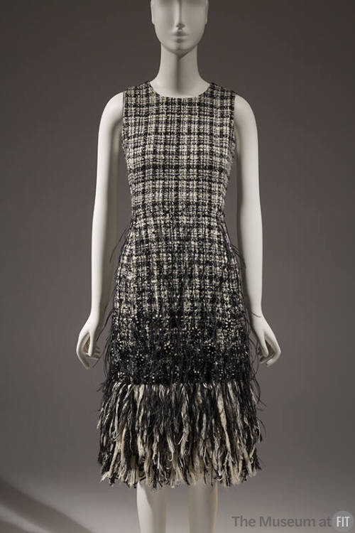 Black and white tweed sleeveless dress with extended hem fringe of feathers 