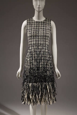 Black and white tweed sleeveless dress with extended hem fringe of feathers 
