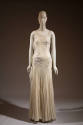 Ivory floor length sleeveless evening dress with white floral embroidery throughout bodice and …
