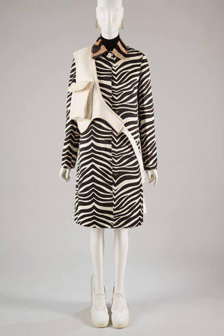 Black and white zebra print coat with white patch pocket cross body bag, white sneakers and ear…
