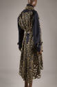 Back view of navy blue trench coat with gold metallic floral lace overlay throughout and high-l…