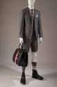 Grey suit with long sleeve blazer, matching Bermuda shorts, black ankle boots and large black l…