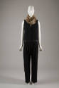 Black sleeveless jumpsuit with satin waistband and faux fur neck warmer