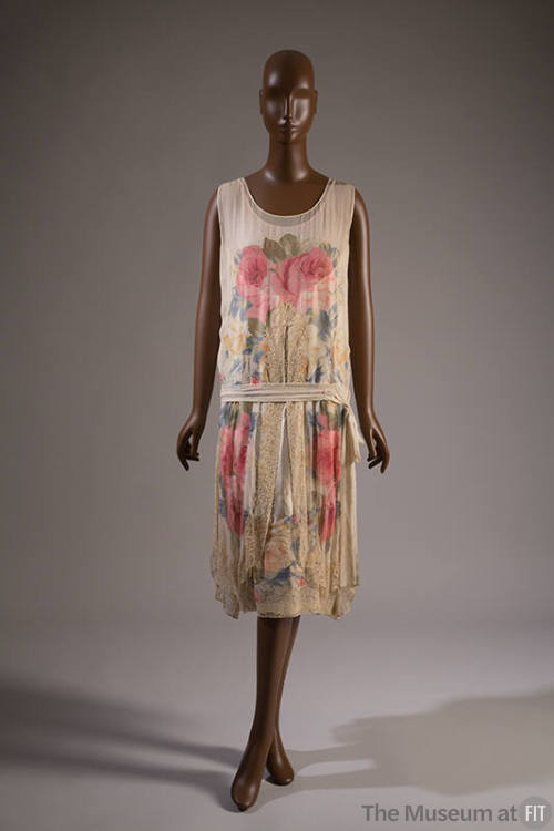 Ivory sleeveless evening dress with large pink, blue and gold floral print, drop waist with tie…