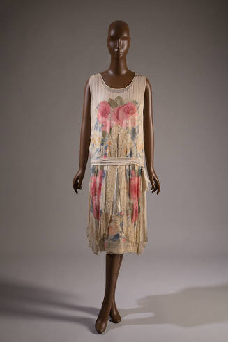 Ivory sleeveless evening dress with large pink, blue and gold floral print, drop waist with tie…