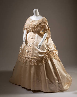 Cream silk satin dress with lace overlay on bodice, ¾ length sleeves with ruffles and wide floo…