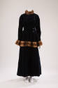 Dark blue velvet jacket with side buttons and brown fur trim on stand collar and peplum hem wit…