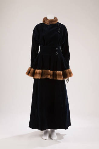 Dark blue velvet jacket with side buttons and brown fur trim on stand collar and peplum hem wit…