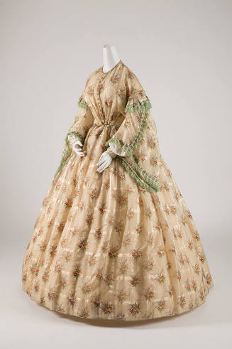 Beige floor length dress in multicolor floral print with large bell sleeves trimmed with green …