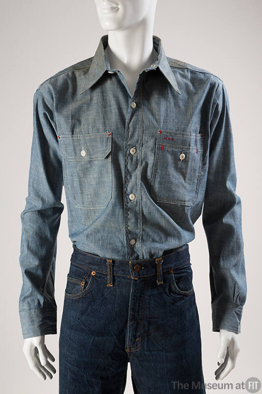 Blue denim long sleeve tailored shirt with button front, two buttoned patch pockets and red sti…