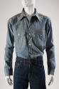 Blue denim long sleeve tailored shirt with button front, two buttoned patch pockets and red sti…