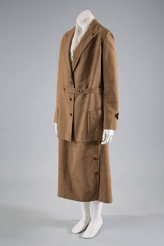 Tan long sleeve jacket, three button front, patch pockets, matching ankle length skirt with sid…