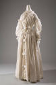 White cotton long sleeve gown with eyelet ruffles and trim, floor-length gathered skirt with bu…