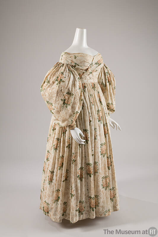 Off the shoulder, off-white day dress with floral print, long puffed sleeves, and long gathered…