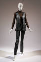 Black leather button front vest, brown turtleneck long sleeve top and black leather pants