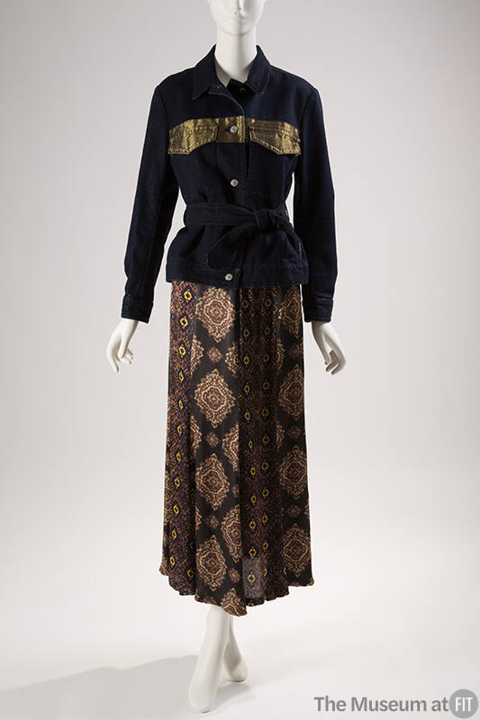 Dark blue denim jacket with metallic gold band at chest, button front and tie belt with floor l…