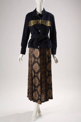 Dark blue denim jacket with metallic gold band at chest, button front and tie belt with floor l…